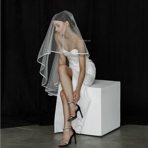 Ivory knee length veil with waist length blusher. Satin trim. Brand new.
